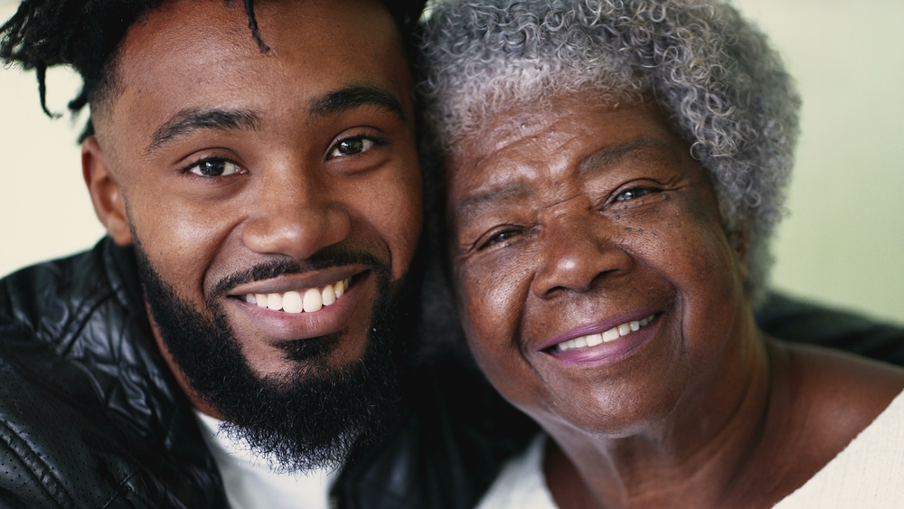 Adult,Grandson,Embracing,Senior,Grandmother,Authentic,And,Real,Life